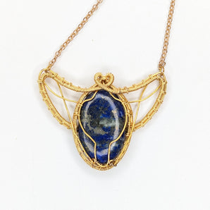 Scarab inspired lapis lazuli wire wrapped pendant in gold plated wire